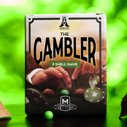 Three shell game magic trick set called The Gambler with three tan shells and a green rubber pea on a white background